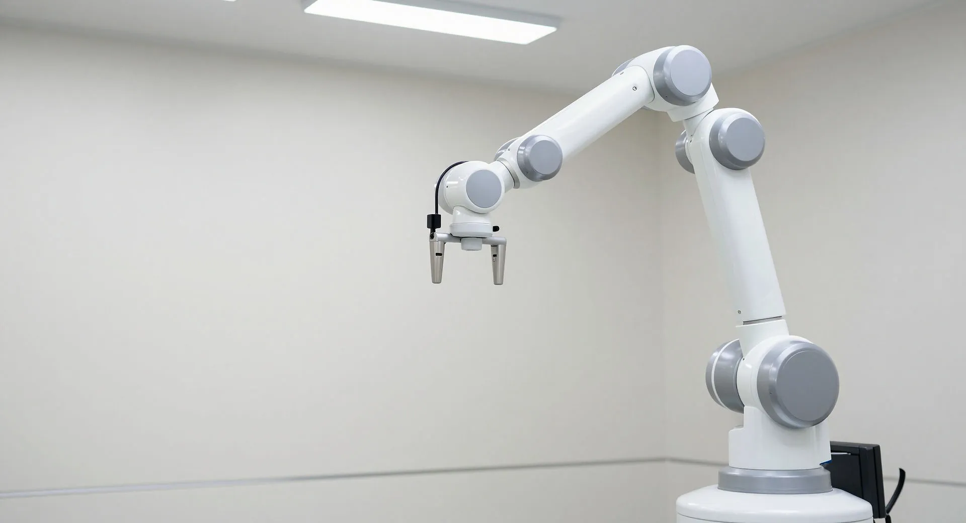 White robotic arm poised in a clean clinical workspace